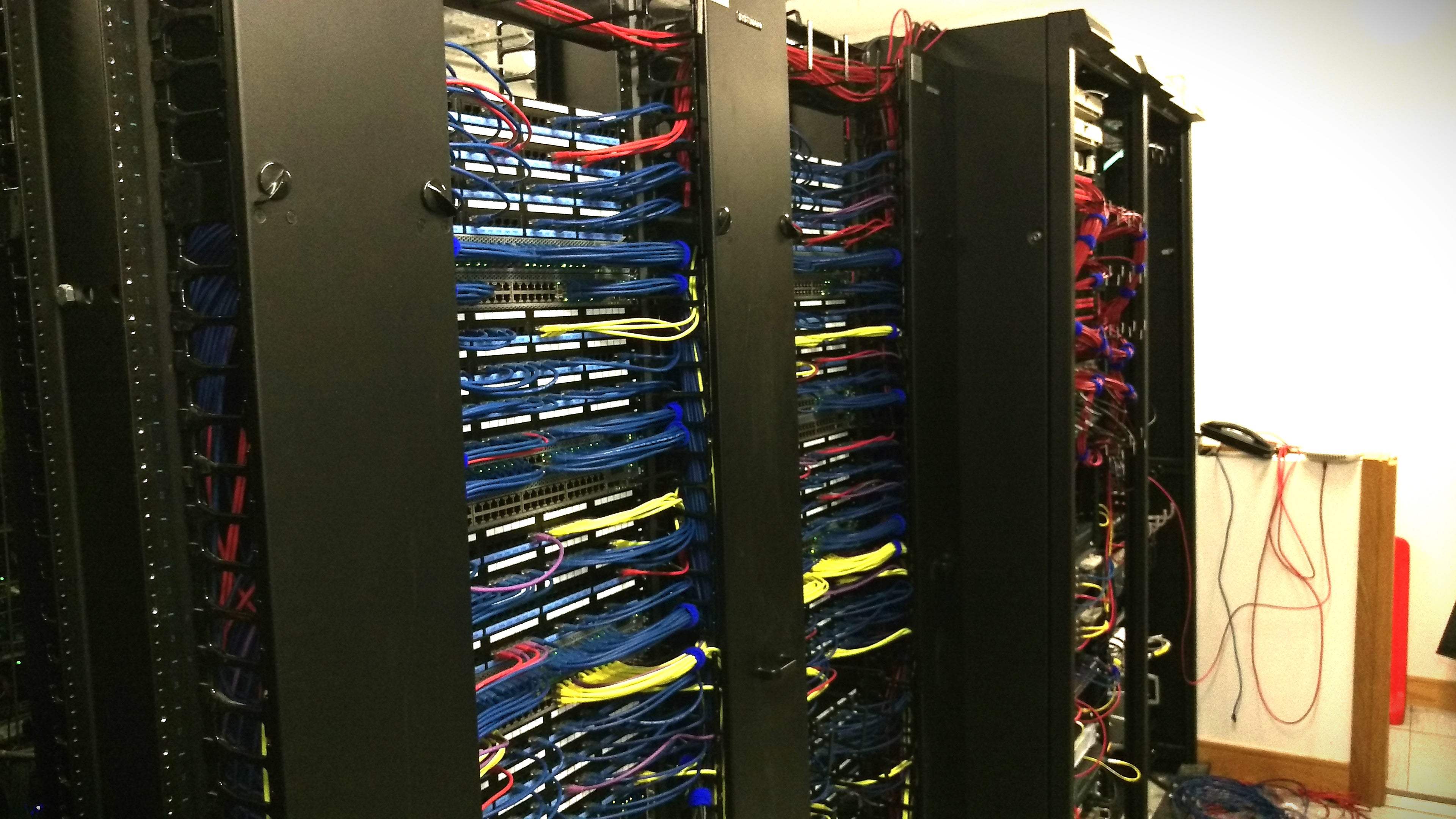 Server cabinets with numerous cables in a data center setting