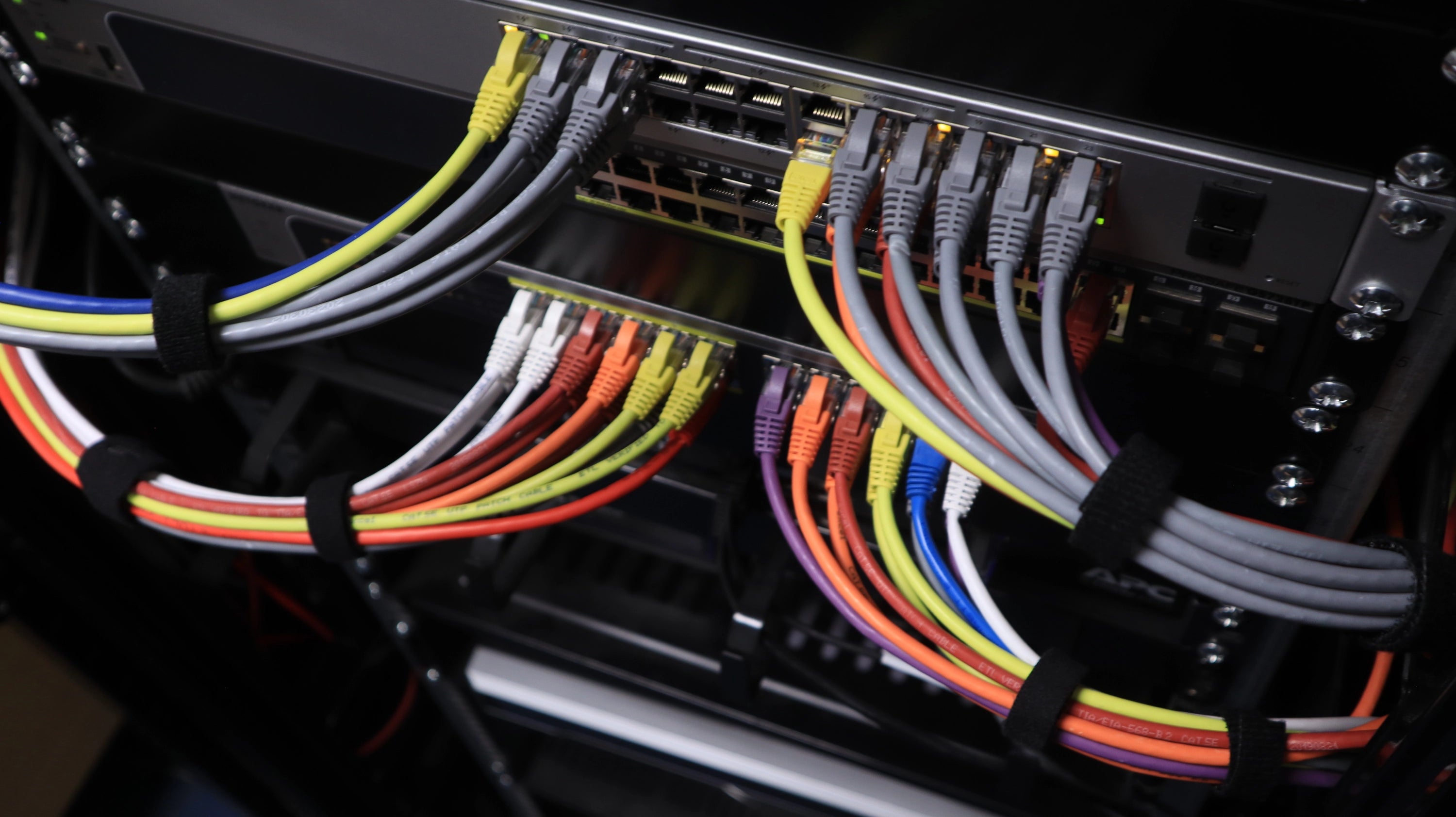 Close-up of a computer case with colorful cables and a focus on cable management.