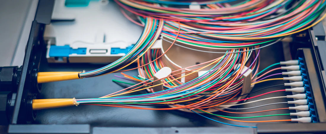 Close-up of fiber optic cables inside a network equipment box