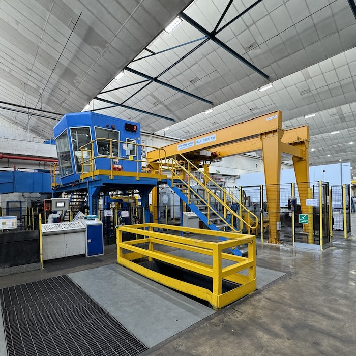 Industrial setting with large blue and yellow machinery in a warehouse.